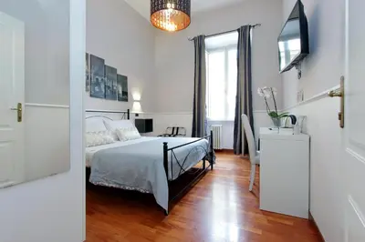 a white bedroom with a bed and a window at 4BNB - Otranto Vatican Apartment in Rome