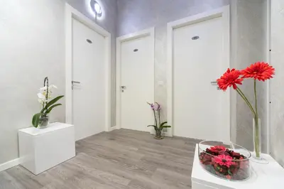 a room with a vase of flowers on a table at Sweet Holidays In Rome in Rome
