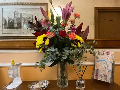 a vase filled with flowers on a table at Baltik Guesthouse in Rome