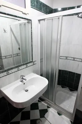 a bathroom with a sink and a shower at Baltik Guesthouse in Rome
