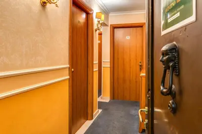 a hallway with a mask on the door at Baltik Guesthouse in Rome