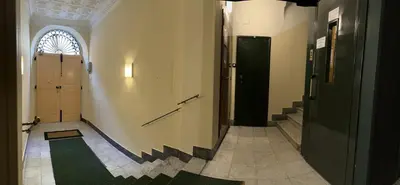a hallway with two doors and a green carpet at Baltik Guesthouse in Rome