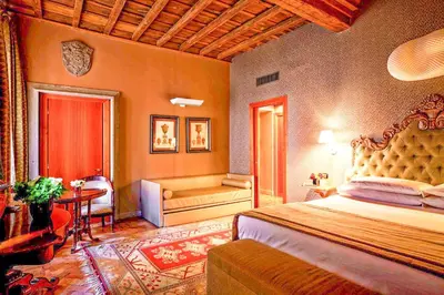 a bedroom with a bed and a room with a window at Hotel Valadier in Rome