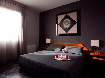 a bedroom with a bed with a tray of food on it at Hotel Zone in Rome