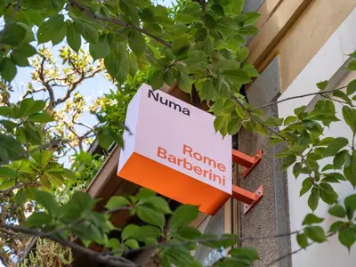 a sign on a building that reads nuna roma barcelona at Numa Rome Barberini in Rome