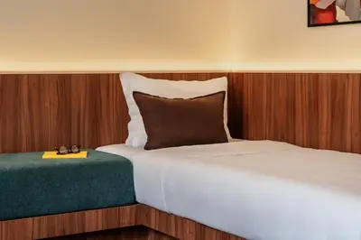 a bedroom with a bed and a pillow and a table at Numa Rome Barberini in Rome