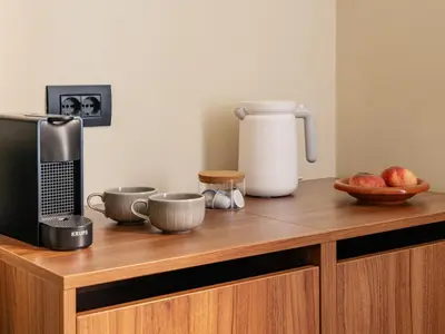 a kitchen counter with a microwave and a coffee maker at Numa Rome Barberini in Rome