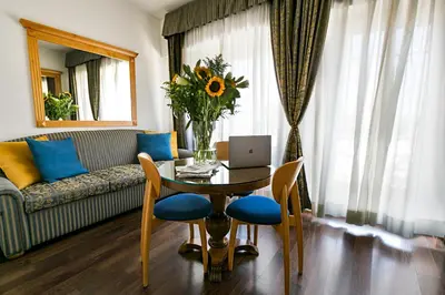 a living room with a television on a wooden desk at Hotel Diplomatic in Rome