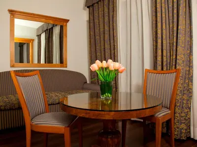 a table with wine glasses and a mirror in a room at Hotel Diplomatic in Rome