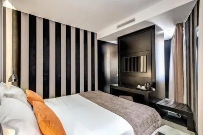 a hotel room with a bed and a television at Doria Palace Boutique Hotel in Rome