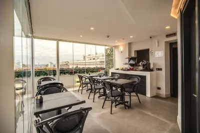 a restaurant with tables and chairs and a large window at Doria Palace Boutique Hotel in Rome