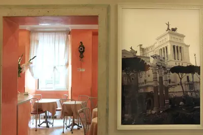 a dining room with a table and a picture of a building at Hotel Kent in Rome