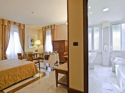 a hotel room with a bed and a bathroom at Tmark Hotel Vaticano in Rome