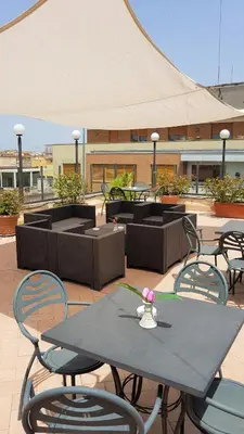 a table and chairs sitting on a patio at Tmark Hotel Vaticano in Rome