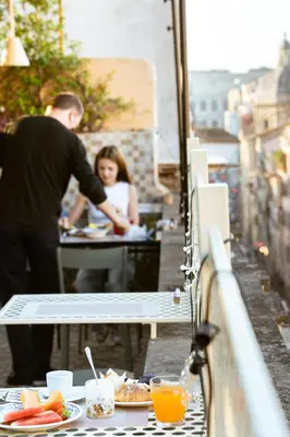 a man standing at a table with a plate of food at Condominio Monti Boutique Hotel in Rome