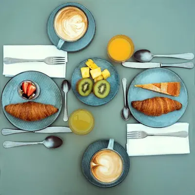 a table with plates of food and cups of coffee at Condominio Monti Boutique Hotel in Rome
