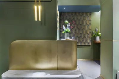 a gold bench in a room with green walls at Condominio Monti Boutique Hotel in Rome