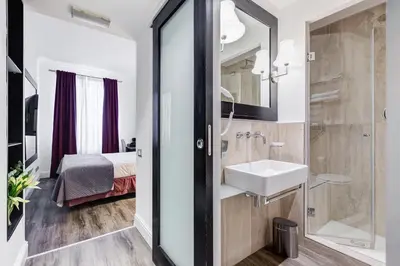 a bathroom with a sink and a shower at Residenza A -Via Veneto Fashion Rooms -self check-in in Rome
