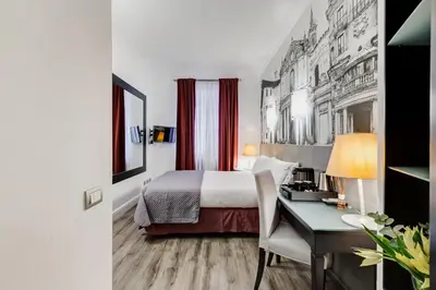 a hotel room with a bed and a desk at Residenza A -Via Veneto Fashion Rooms -self check-in in Rome