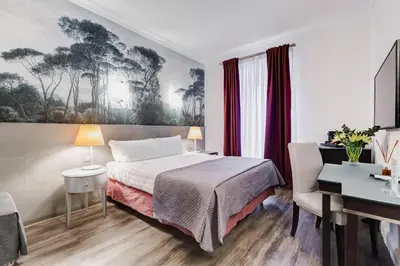 a hotel room with a bed and a desk at Residenza A -Via Veneto Fashion Rooms -self check-in in Rome
