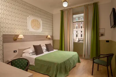 a hotel room with a bed and a window at Hotel Dorica in Rome