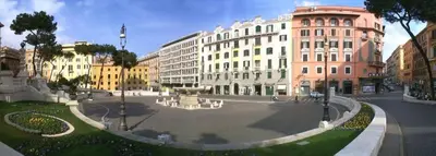 a large courtyard in a city with buildings at Hotel Dorica in Rome