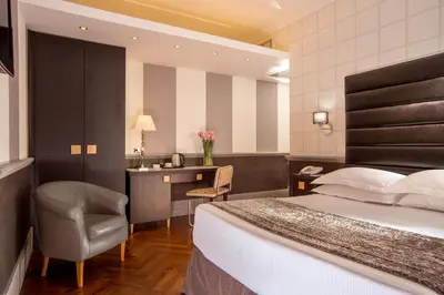 a hotel room with a bed and a desk at Hotel Royal Court in Rome