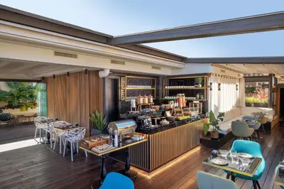 a restaurant with a bar and tables and chairs at Hotel Del Corso in Rome