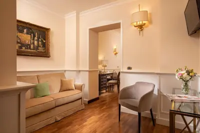 a living room with a couch and a table at Hotel Del Corso in Rome