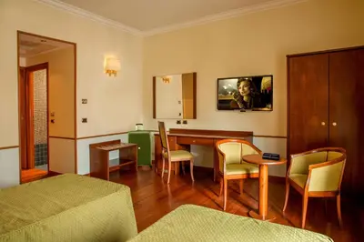 a living room with a table and chairs at Hotel Piemonte in Rome