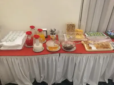 a red table with food on top of it at Hotel Villa Delle Rose in Rome
