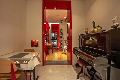 a kitchen with a piano and a dining room at Hotel White in Rome