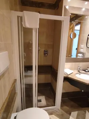 a bathroom with a shower and a toilet and a sink at Hotel White in Rome