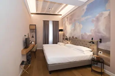a bedroom with a bed and a painting on the wall at Hotel Accademia in Rome