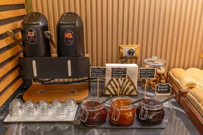 a table with jars of honey and jars of jam at Hotel Accademia in Rome