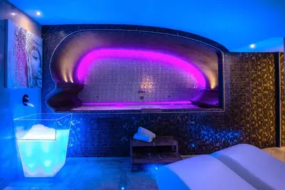 a bathroom with a tub with purple lighting at Hotel Accademia in Rome