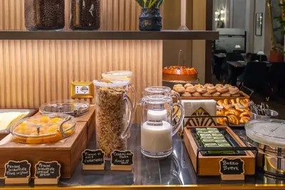 a buffet with bread and other food on a table at Hotel Accademia in Rome