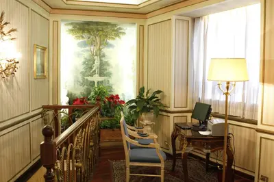 a room with a desk and a table with a computer at Hotel Eliseo in Rome