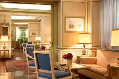 a living room with a couch and a table and chairs at Hotel Eliseo in Rome