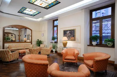 a waiting room with chairs and tables and windows at Hotel Torino in Rome