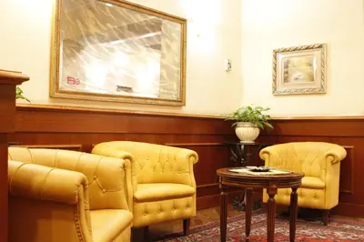 a waiting room with two chairs and a table at Hotel Torino in Rome
