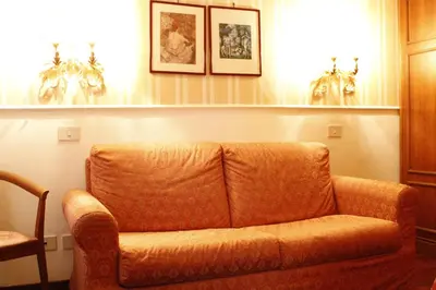 an orange couch sitting in a living room at Hotel Torino in Rome