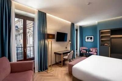 a hotel room with a bed and a desk at The Major Hotel in Rome