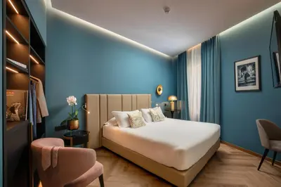 a hotel room with a bed and a chair at The Major Hotel in Rome