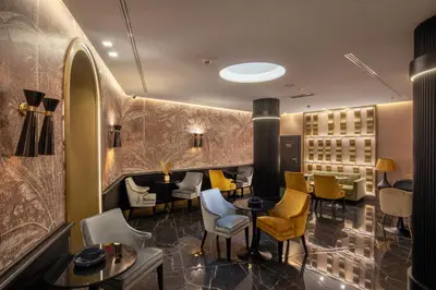 a restaurant with yellow chairs and tables in a room at The Major Hotel in Rome