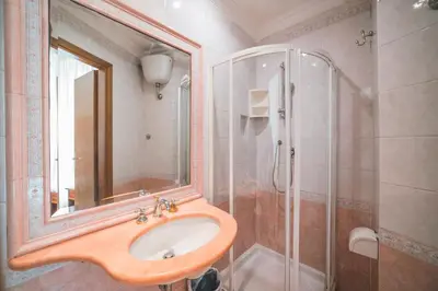a bathroom with a sink and a shower at GH Hotel San Giusto in Rome