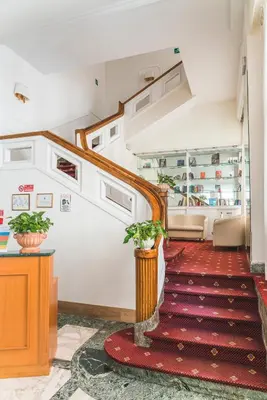 a stairway with a red rug and a red carpet at GH Hotel San Giusto in Rome