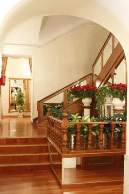 a room with a staircase with potted plants on it at Hotel Pace Helvezia in Rome