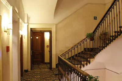 a hallway with stairs and a door in a building at Hotel Pace Helvezia in Rome