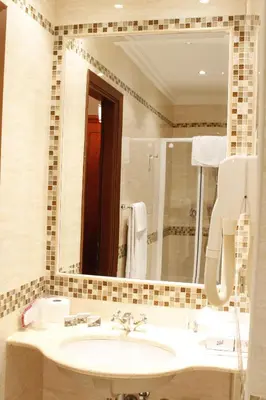 a bathroom with a sink and a large mirror at Hotel Genio in Rome